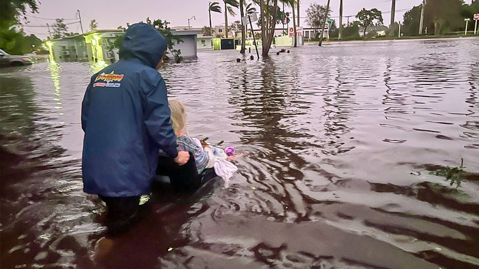 An 86-year-old woman is pushed through floodwaters after being rescued from her home in Naples, Florida, on Sept. 28 following Hurricane Ian. Photo: The Associated Press